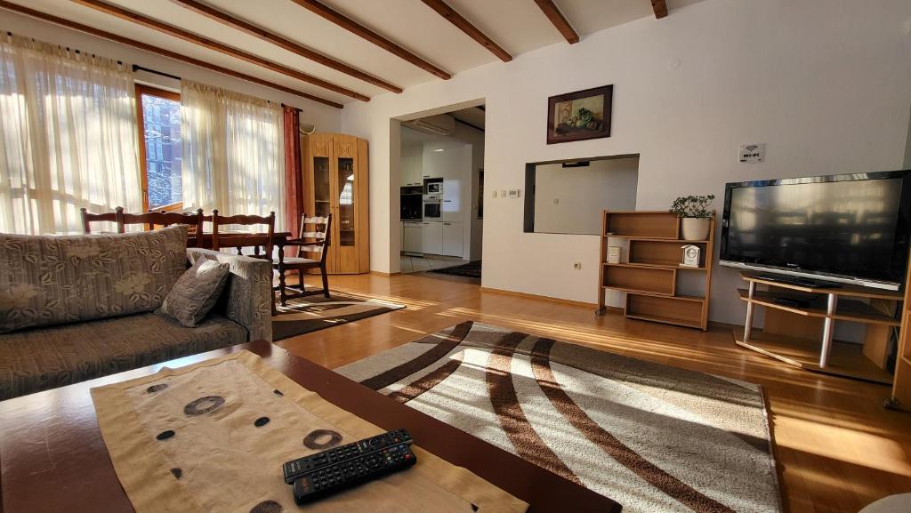a living room with a couch and a flat screen tv at Apartment Cobanija in Sarajevo