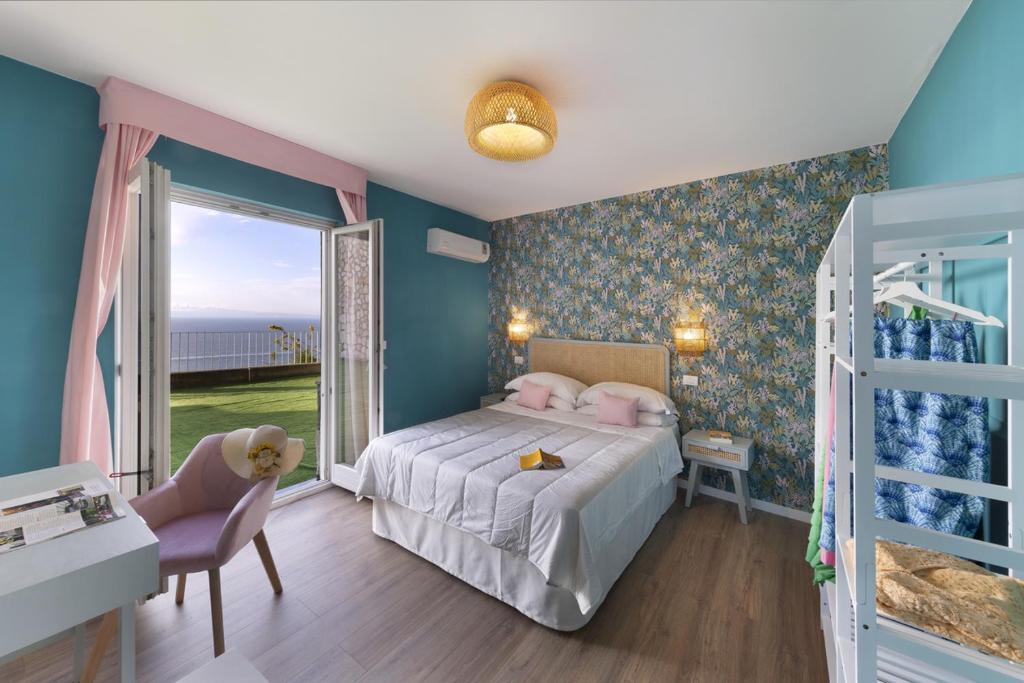 a bedroom with a bed and a large window at Hotel Villa Lubrense Sorrento in Massa Lubrense