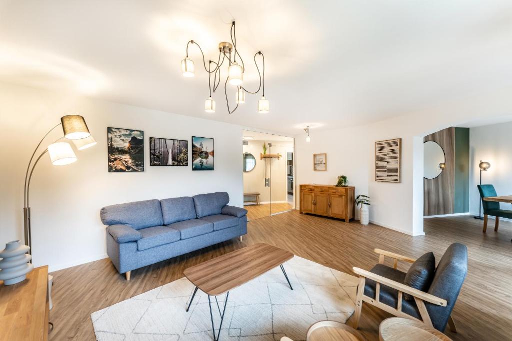 a living room with a blue couch and a table at Juri/4 Bad Dürrheim in Bad Dürrheim