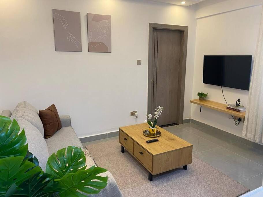 a living room with a couch and a coffee table at 1bedroom Exquisite City Apartment in Kilimani by The Manna Stays in Nairobi