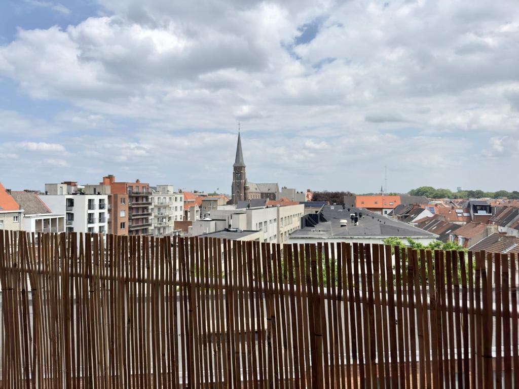 a view of a city from behind a fence at Cosy apartment in Ghent in Ghent