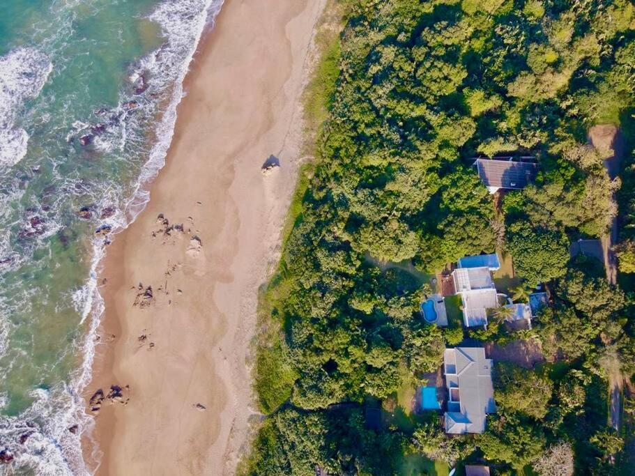 an overhead view of a beach with houses and the ocean at Woodlands Beach Villa in Southbroom