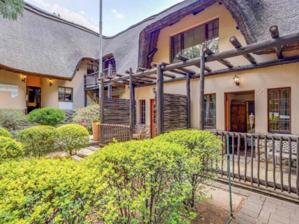 an exterior view of a house with a fence at Lapalosa Lodge in Centurion