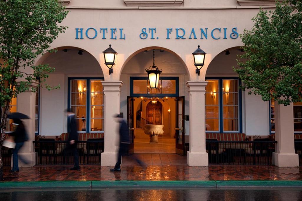 a hotel with people walking in front of a building at Hotel St Francis in Santa Fe