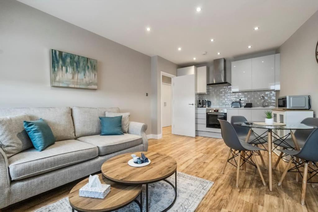 uma sala de estar com um sofá e uma mesa em 2 Bedroom Flat, Wembley Stadium em Londres