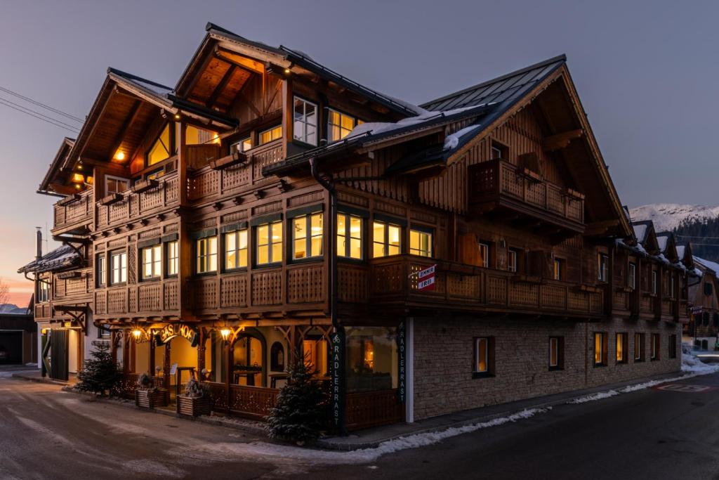 ein großes Holzgebäude mit vielen Fenstern in der Unterkunft Wander- und Wellnesshotel Kanzler in Bad Mitterndorf