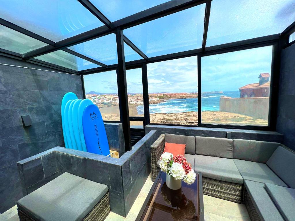 a living room with a view of the ocean at Secret Surf House. Casa de playa. in Playa del Hombre