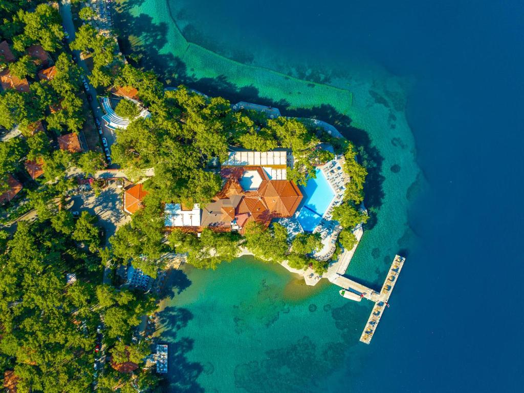 an aerial view of a house on a island in the water at Marmaris Bay Resort - Adults Only in Marmaris