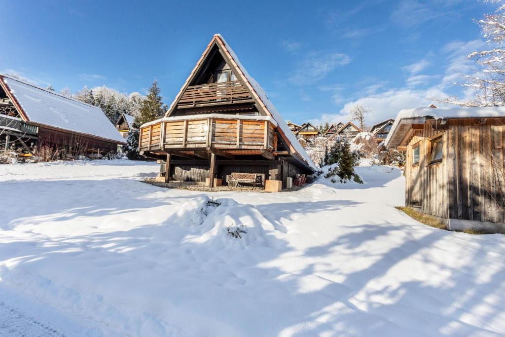 a log cabin in the snow with a barn at Ferienhaus Moritz in Siegsdorf