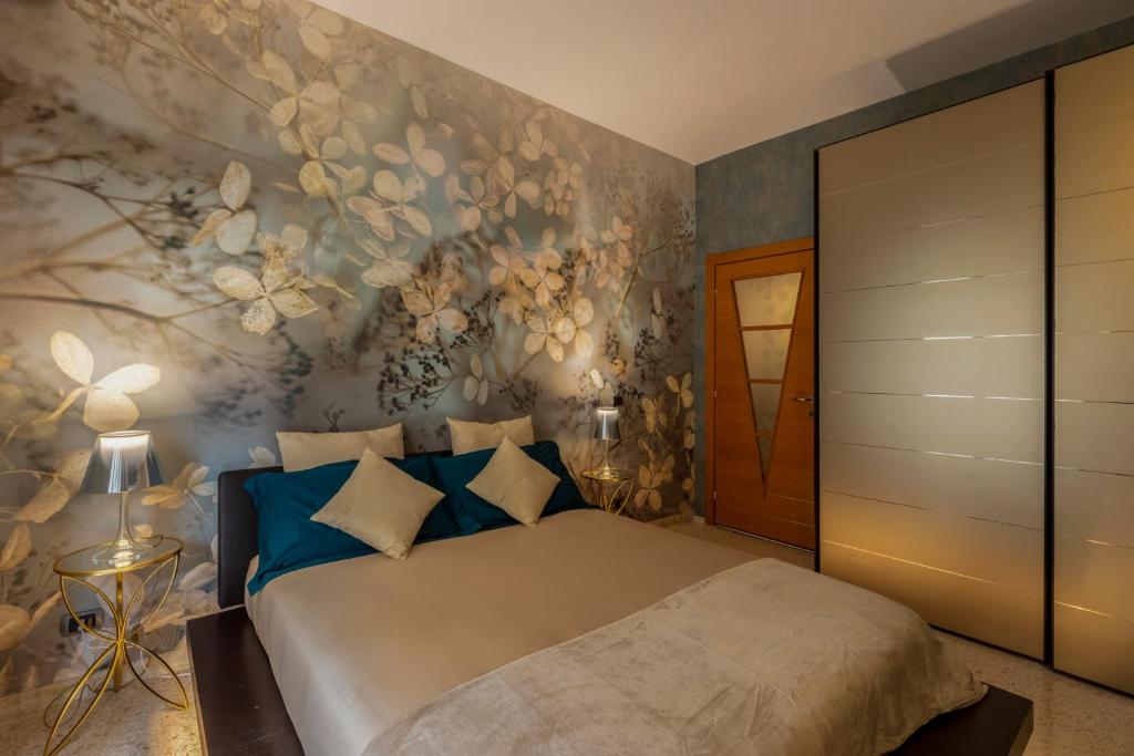 sypialnia z łóżkiem z kwiatową ścianą w obiekcie Rome Elements Apartment w Rzymie