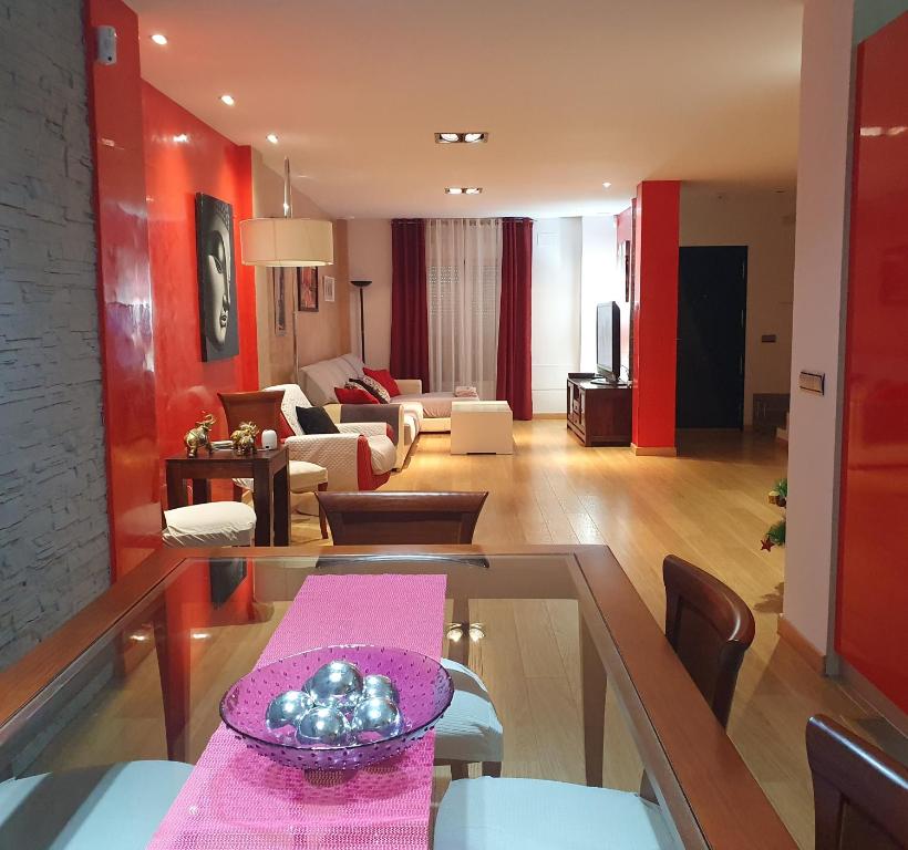 a living room with a table and a living room at La Casa del Bosque in El Bosque
