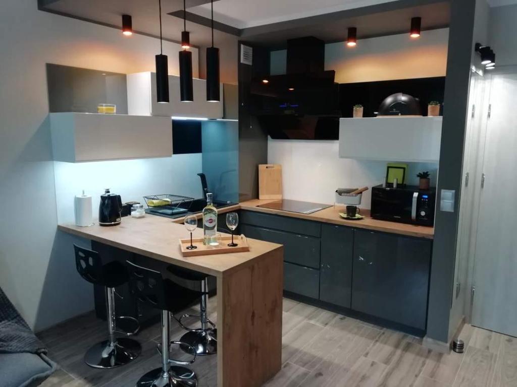 a kitchen with a island in the middle of a room at Apartamenty u Nataszy in Ustrzyki Dolne