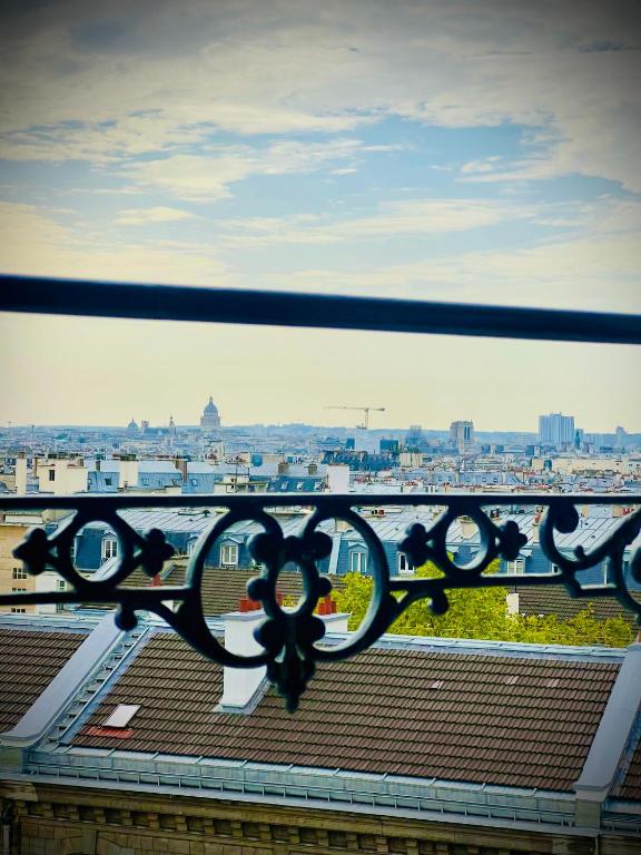 a view of a city from a balcony at Rooms with fabulous view on Paris roofs in Paris