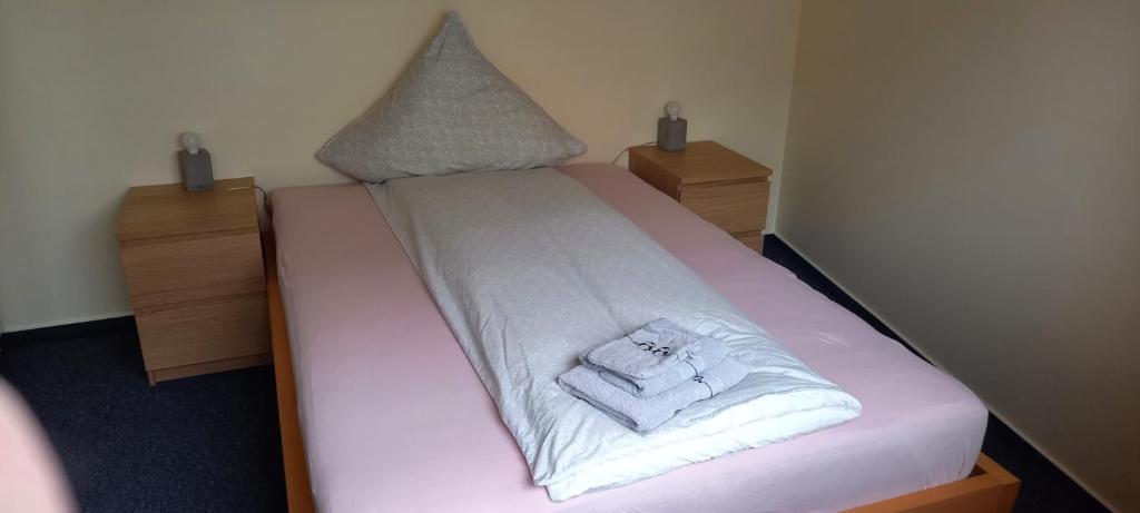 a small bed with white sheets and towels on it at Ferienwohnung Lützowstrasse 2 in Lübeck