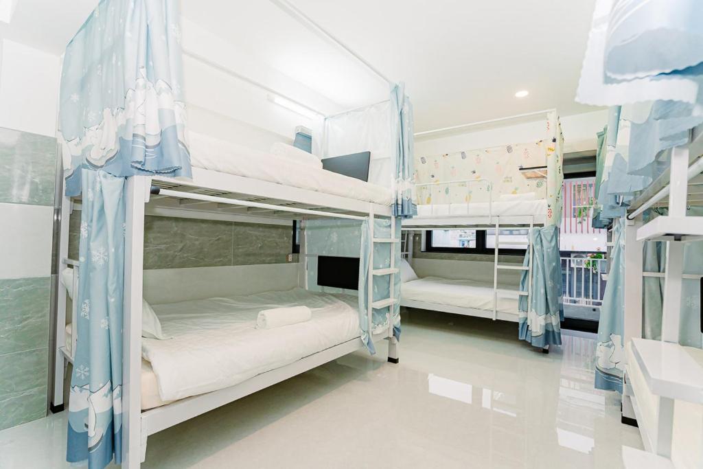 two bunk beds in a hospital room at ALOHA SAIGON HOSTEL by Local Travel Experts - Newly opened, Less-touristy location, Spacious rooms, Glass shower bathroom, Free breakfast, Quiet alley and Cultural exploration in Ho Chi Minh City