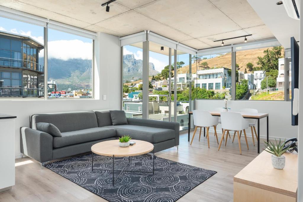 a living room with a couch and a table at The Quarter Luxury Apartments in Cape Town