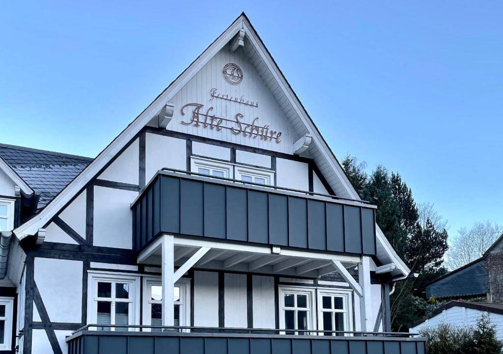 a white and black building with a sign on it at Ferienwohnung Vierländereck nahe Winterberg in Elpe