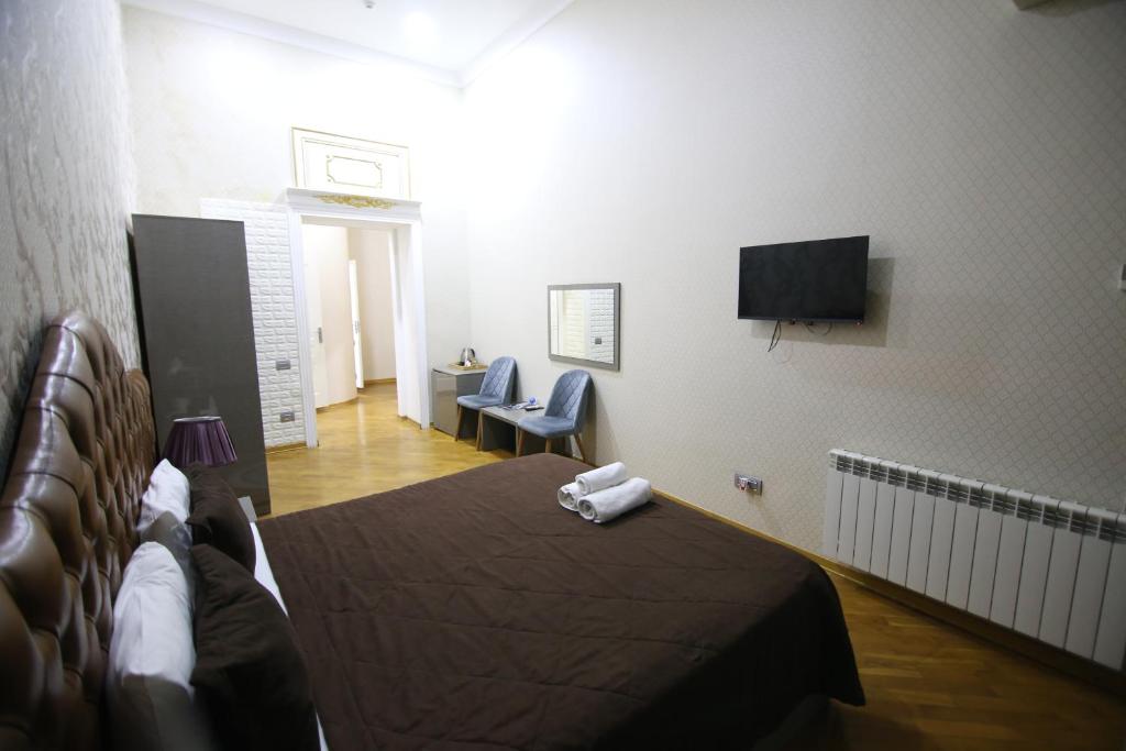 a hotel room with a bed and a television at Prime Pilot center Baku hotel in Baku