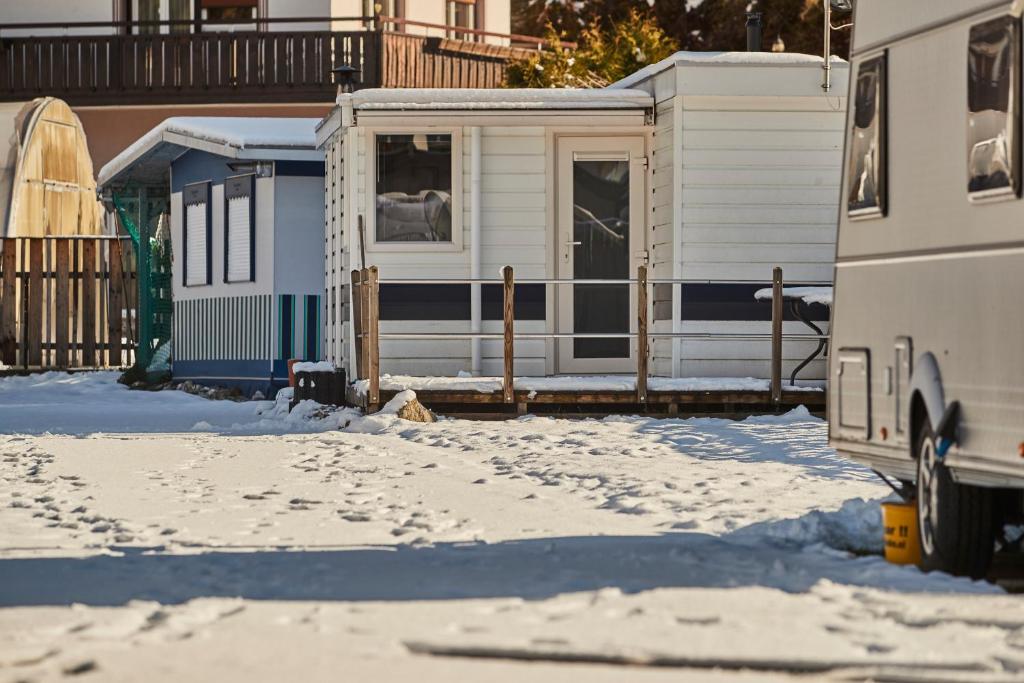 a house with snow in front of it at Mobilheim Alpina in Ried im Oberinntal