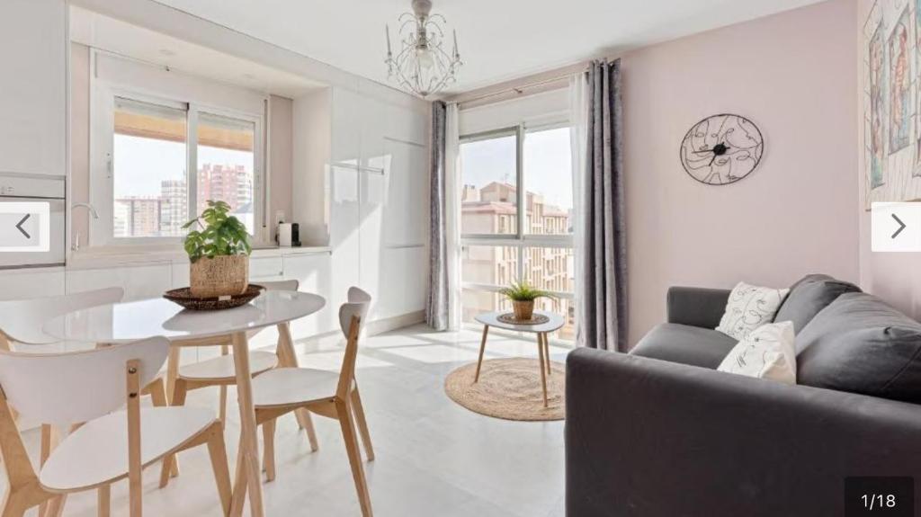 a living room with a couch and a table at Luis Braille Apt in Málaga