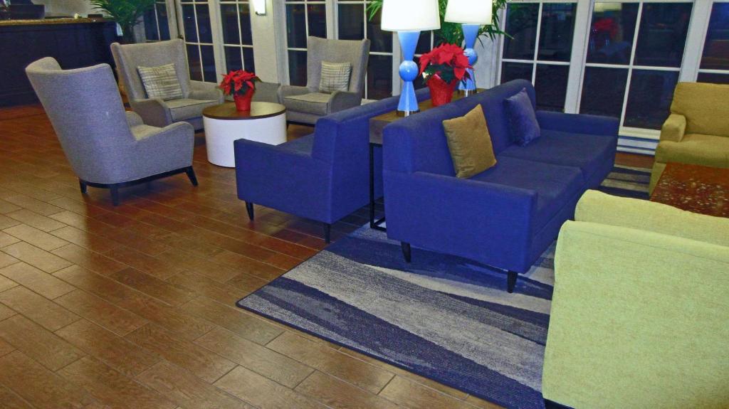 a group of chairs and couches in a lobby at MainStay Suites MSP Airport - Mall of America in Bloomington