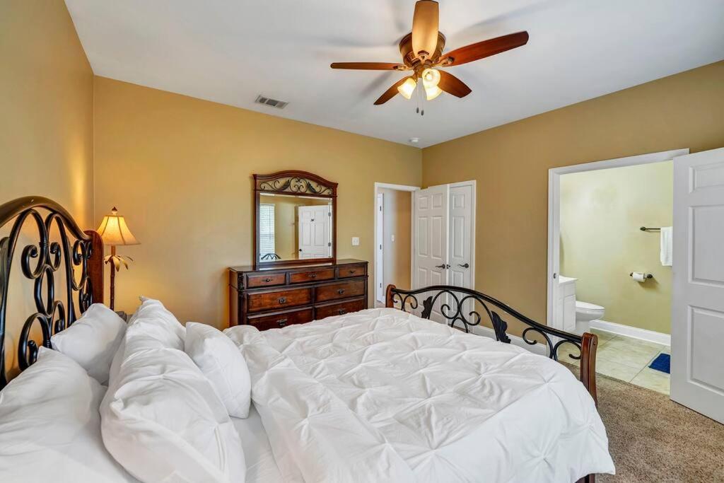 a bedroom with a large white bed with a ceiling fan at 30A Getaway Too! in Santa Rosa Beach