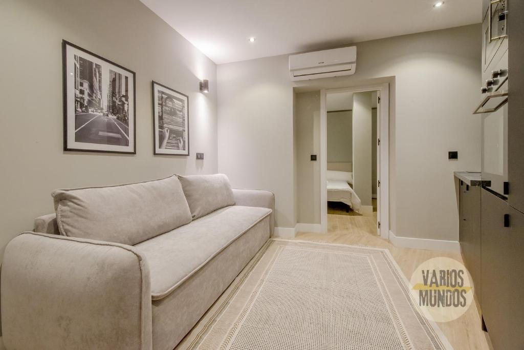 a living room with a couch and a hallway at Urban and Central Apt 5pax en Calle Silva-Gran Via in Madrid