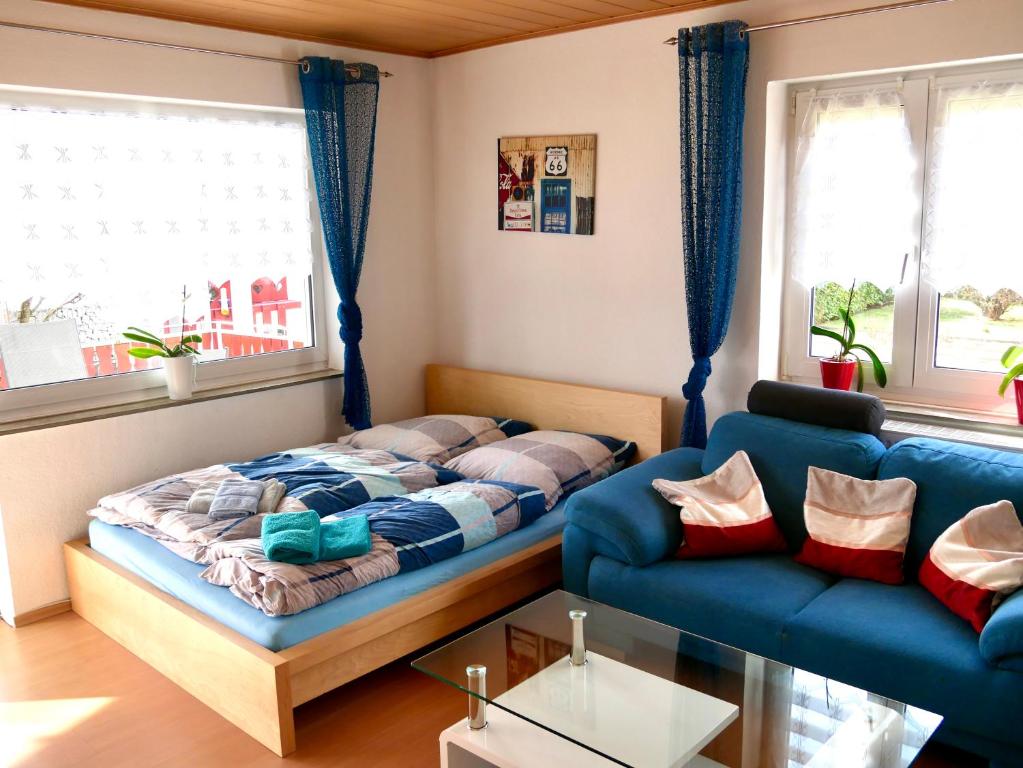 a living room with a bed and a couch at CasaJansen - Große Wohnung im Dreistädte-Eck in Nuremberg