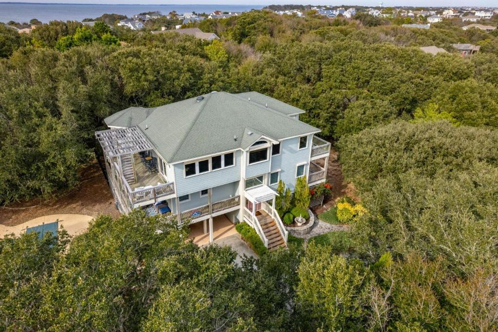 an aerial view of a blue house in the woods at SH157 Chase-n-Grace in Southern Shores