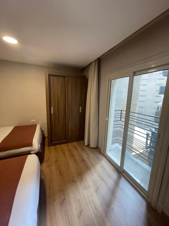 Postel nebo postele na pokoji v ubytování New Lotus Hotel