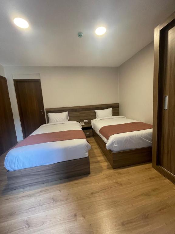 Postel nebo postele na pokoji v ubytování New Lotus Hotel
