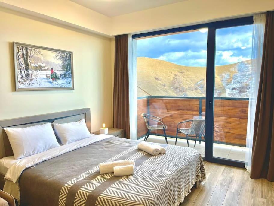 a bedroom with a bed and a large window at New Gudauri Redco, Twins, Near Gondola in Gudauri