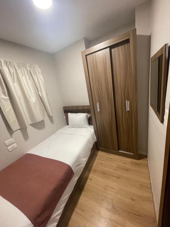 Postel nebo postele na pokoji v ubytování New Lotus Hotel