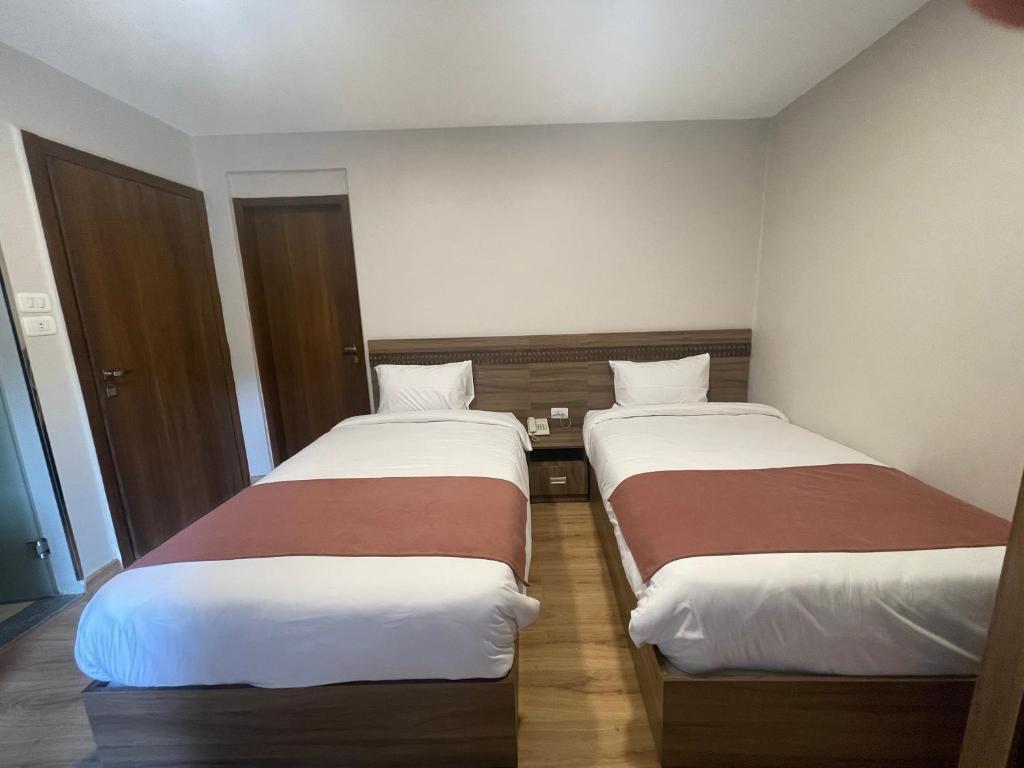 Postel nebo postele na pokoji v ubytování New Lotus Hotel