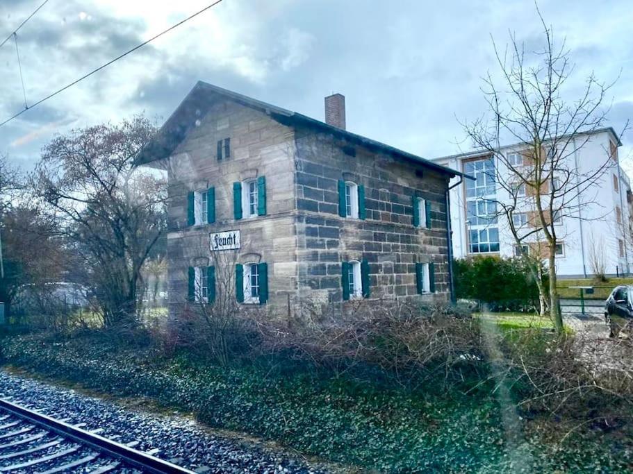 an old stone building next to a train track at Bahnwärterhäuschen - 1873 in Feucht