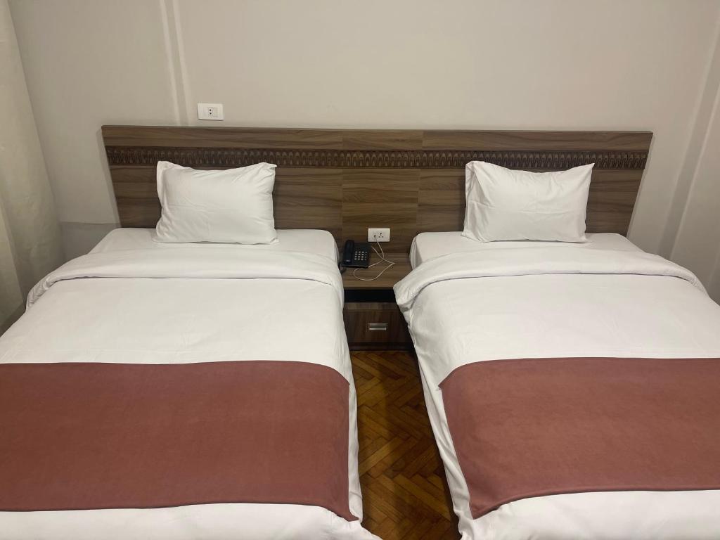 Postel nebo postele na pokoji v ubytování New Lotus Hotel