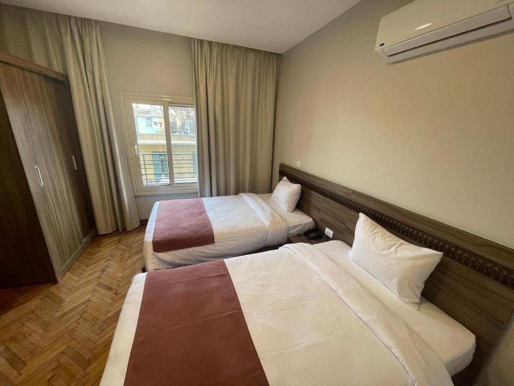 Postel nebo postele na pokoji v ubytování New Lotus Hotel