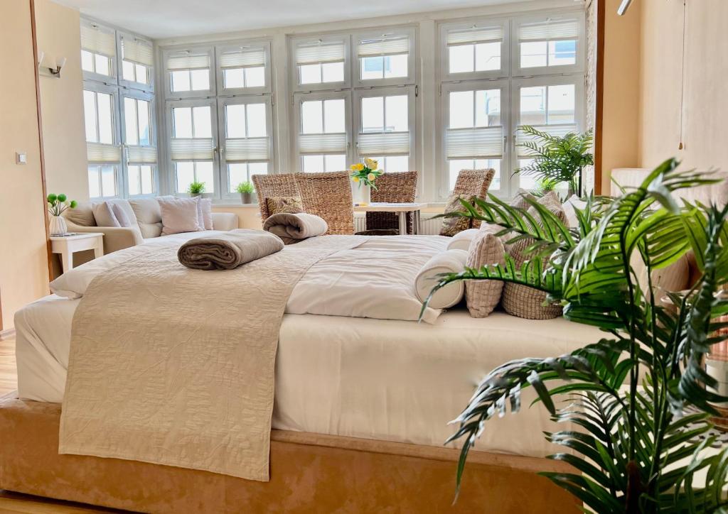 a large bed in a room with windows at Villa Trautes Heim in Ahlbeck