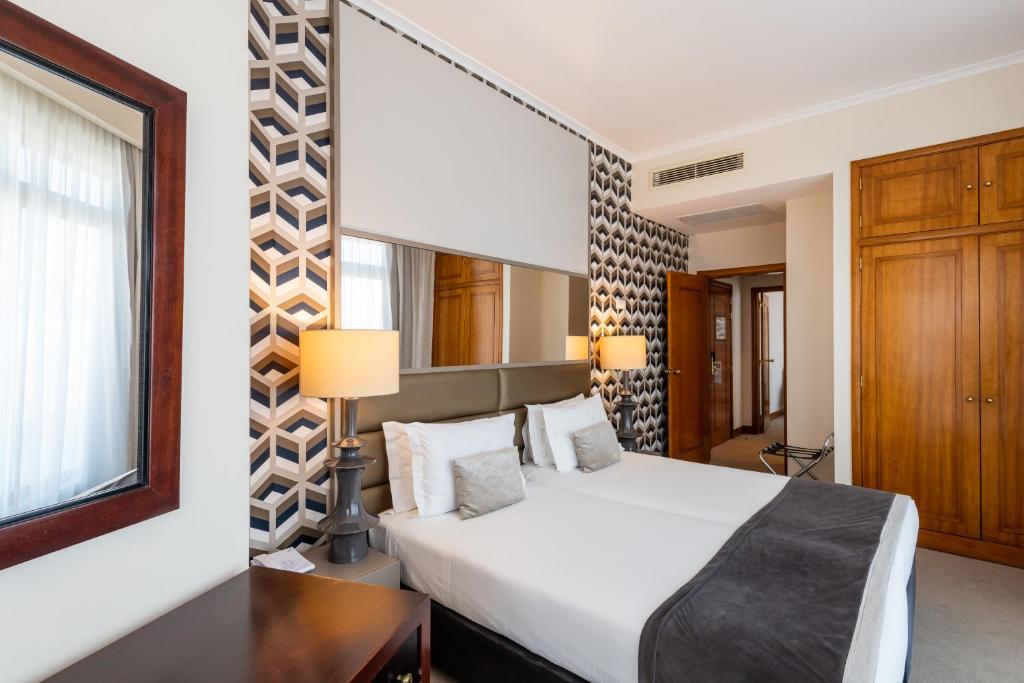 Ein Bett oder Betten in einem Zimmer der Unterkunft Hotel Mundial