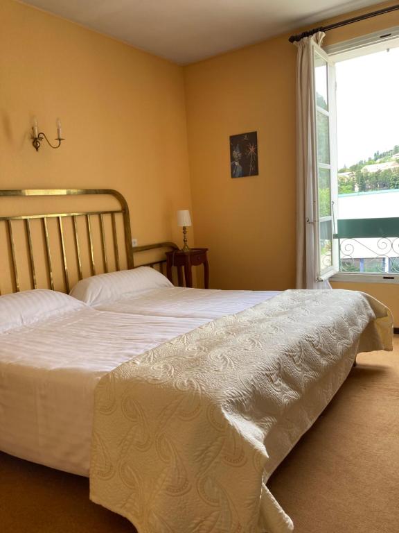Ένα ή περισσότερα κρεβάτια σε δωμάτιο στο Le Grand Paris
