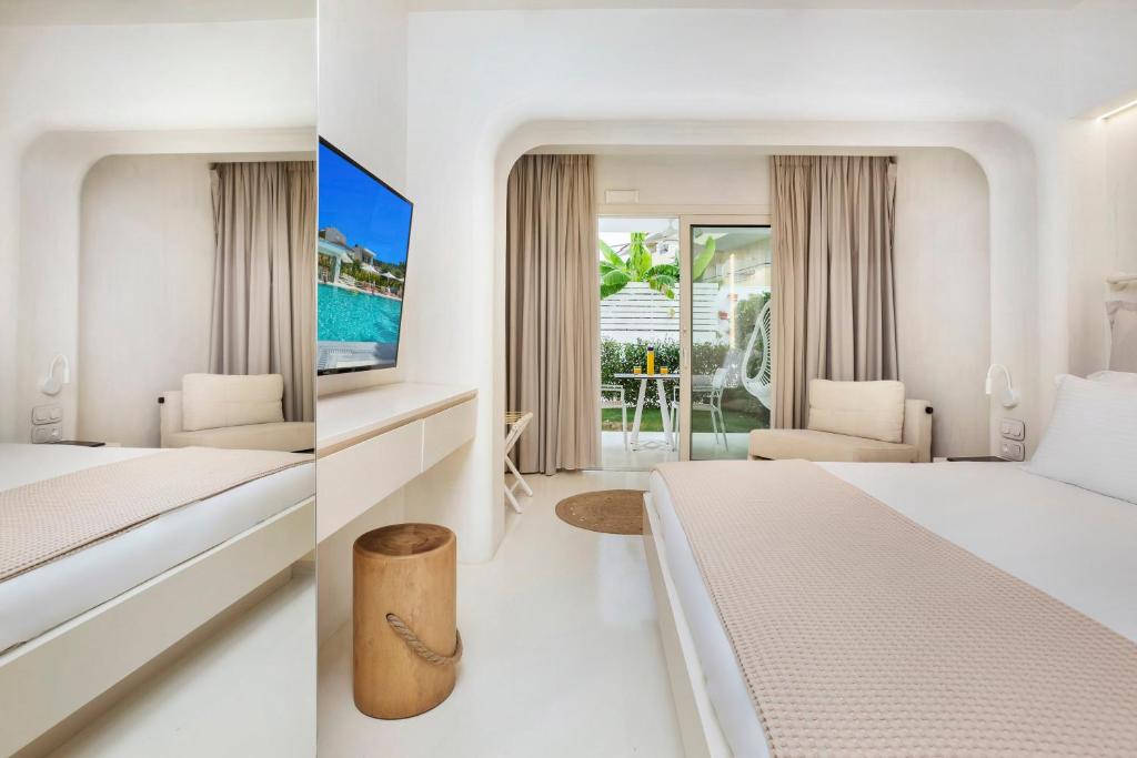 two pictures of a hotel room with a bed and a bedroom at Cocoοns Suites & Villas Fourka in Fourka