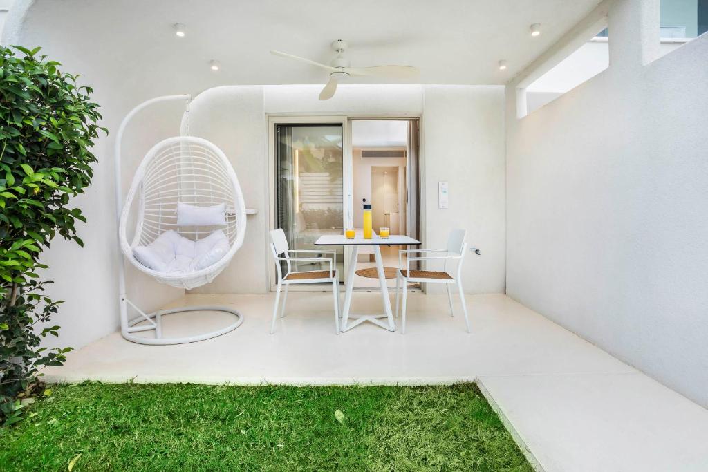 a patio with a table and chairs and a window at Cocoοns Suites & Villas Fourka in Fourka