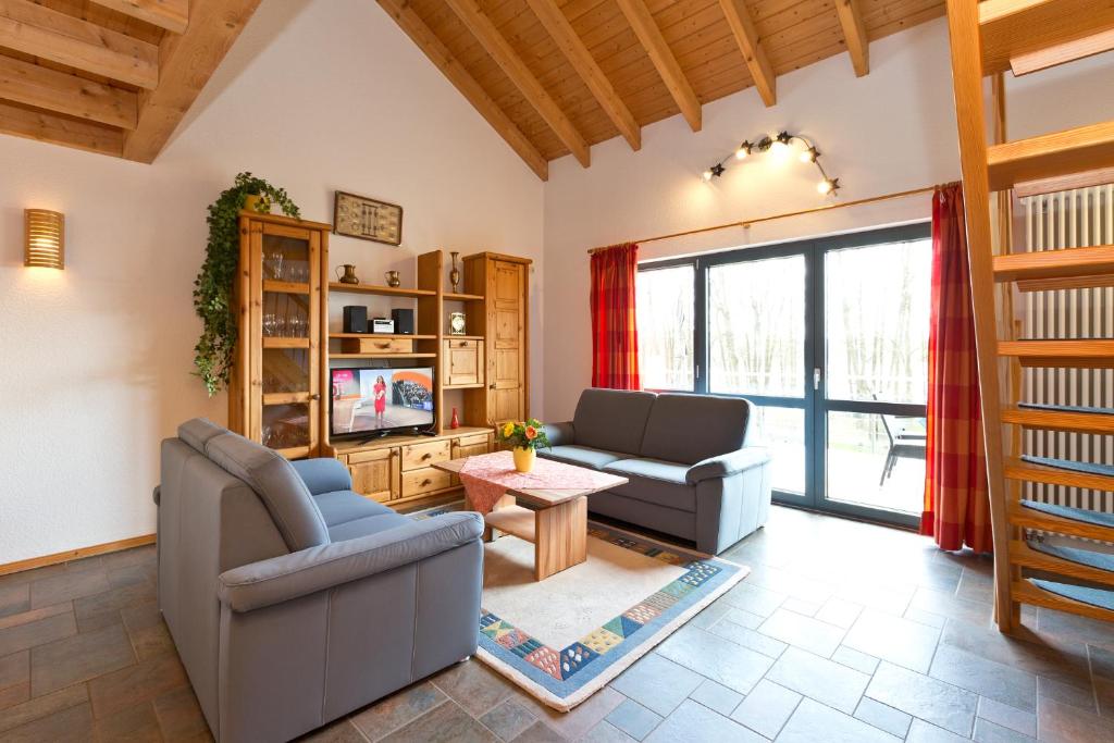 a living room with two couches and a tv at Maribell Appartement in Jabel