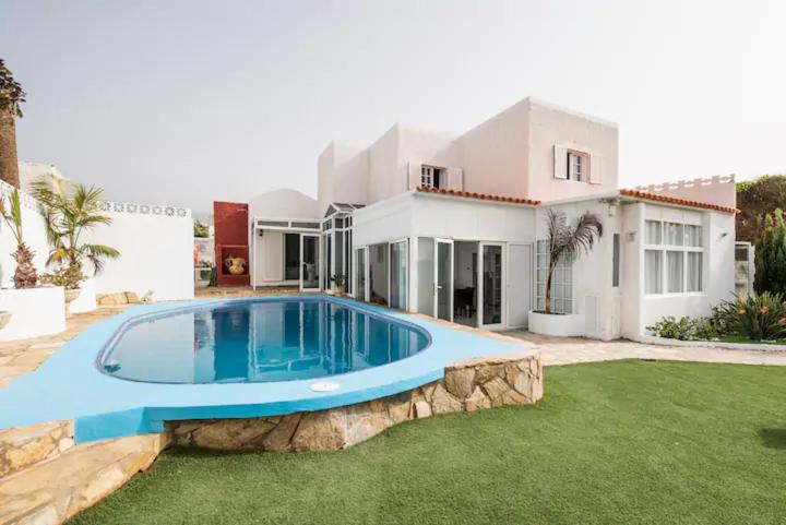 a house with a swimming pool in front of a house at GeDel Ma Zen Resort in Poris de Abona