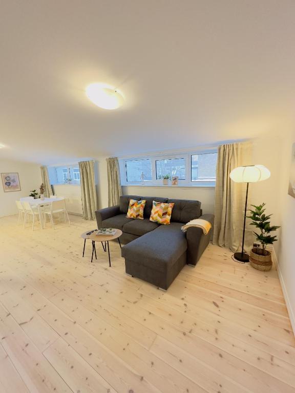 a living room with a couch and a table at aday - Holiday Apartment in the heart of Frederikshavn in Frederikshavn