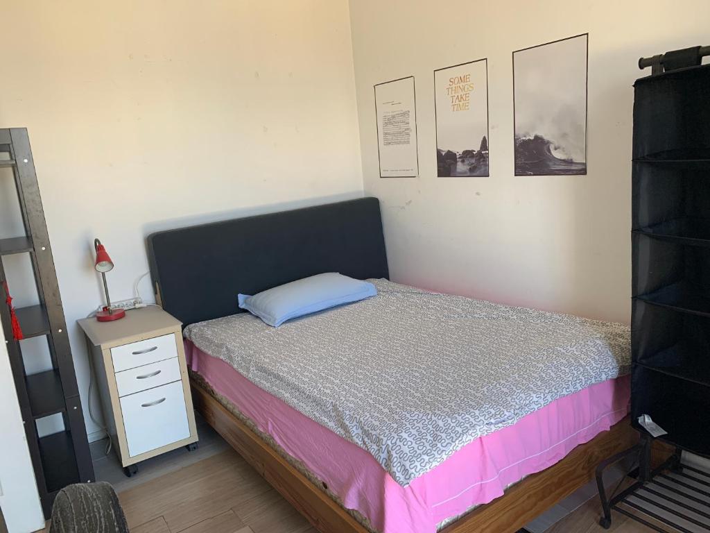 a small bedroom with a bed and a night stand at Une Chambre simple accès direct Aéroport d'Orly T4 in Orly