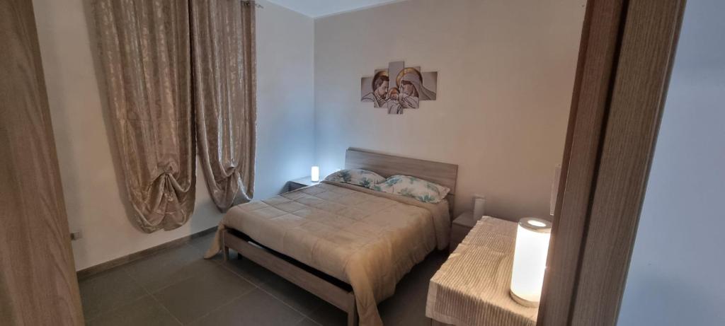 a small bedroom with a bed and a window at ADRIANA SEAHOUSE in Balestrate