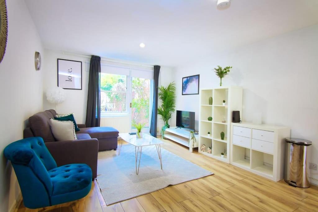 a living room with a couch and a table at Two Bed House near Kings Cross in London