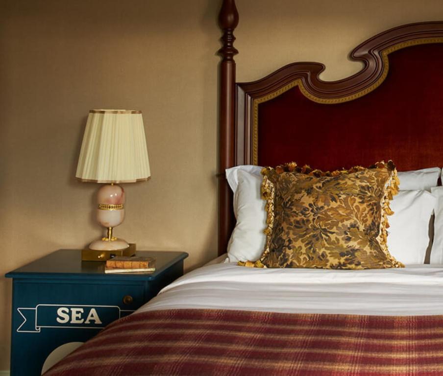 a bedroom with a bed and a lamp on a table at Marine North Berwick in North Berwick