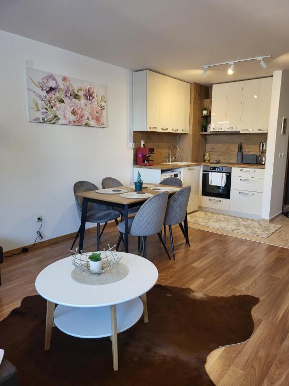 a living room with a table and chairs and a kitchen at Beautiful Apartment in Bansko